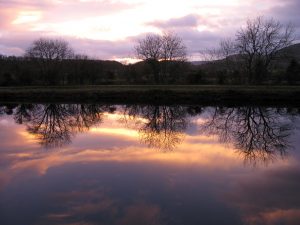 Image of loch at sunset with sky reflected